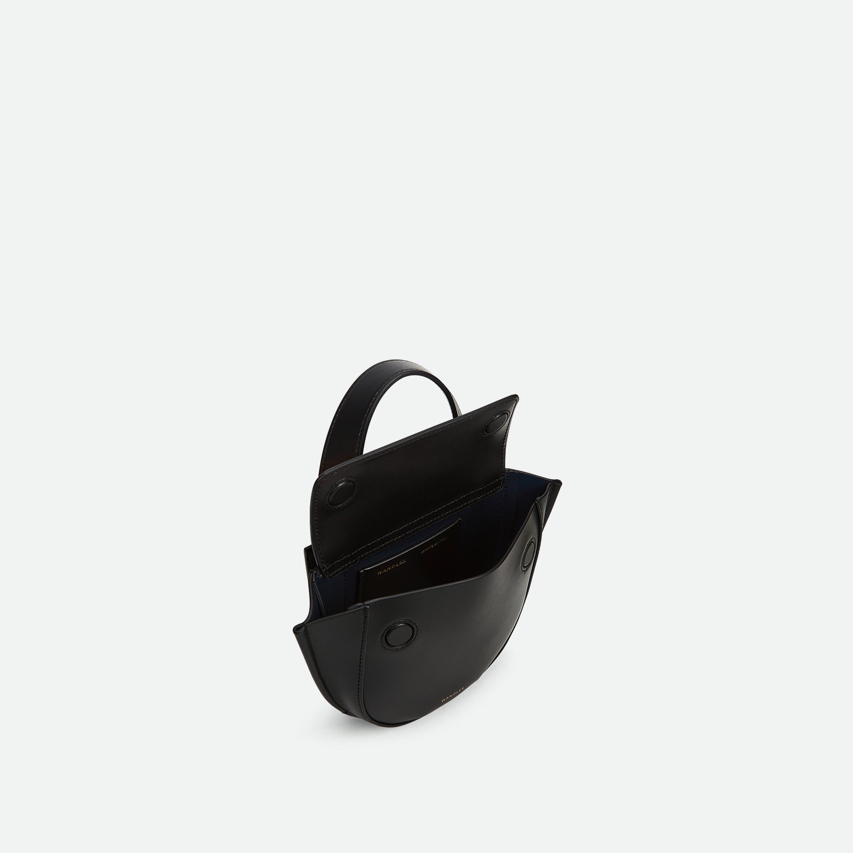 Wandler Hortensia Bag Piccola in the color Black made from Italian calf leather with golden hardware and rounded silhouette. The bag is pictured from the three quarters above with the flap open, giving a slight view of the inside of the bag.
