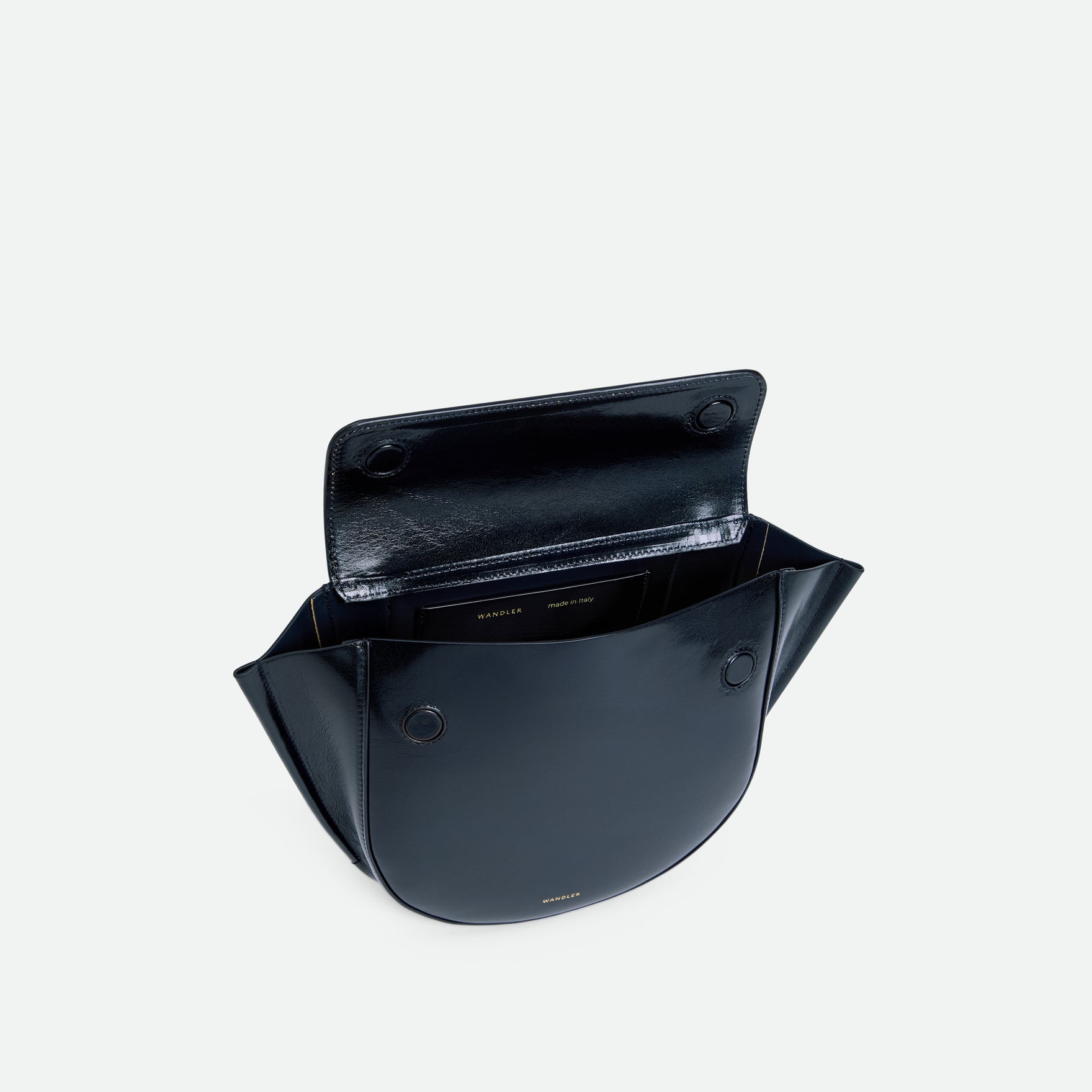 Wandler Hortensia Bag Small in the color Orion Glaze, deep dark blue, Italian calf leather with golden hardware and rounded silhouette. The bag is pictured from the front with the flap open, giving a slight view of the inside of the bag.