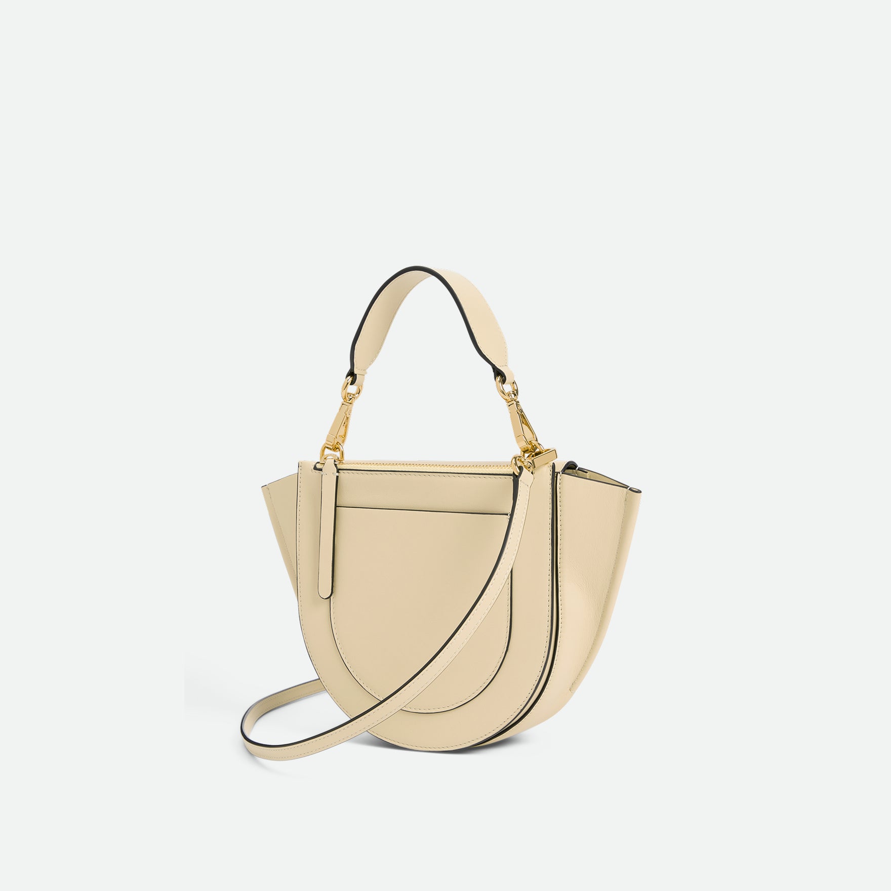 Wandler Hortensia Bag Mini in the color Linen, beige, made from Italian calf leather with golden hardware, rounded silhouette and top handle, backside view, three quarters angle.