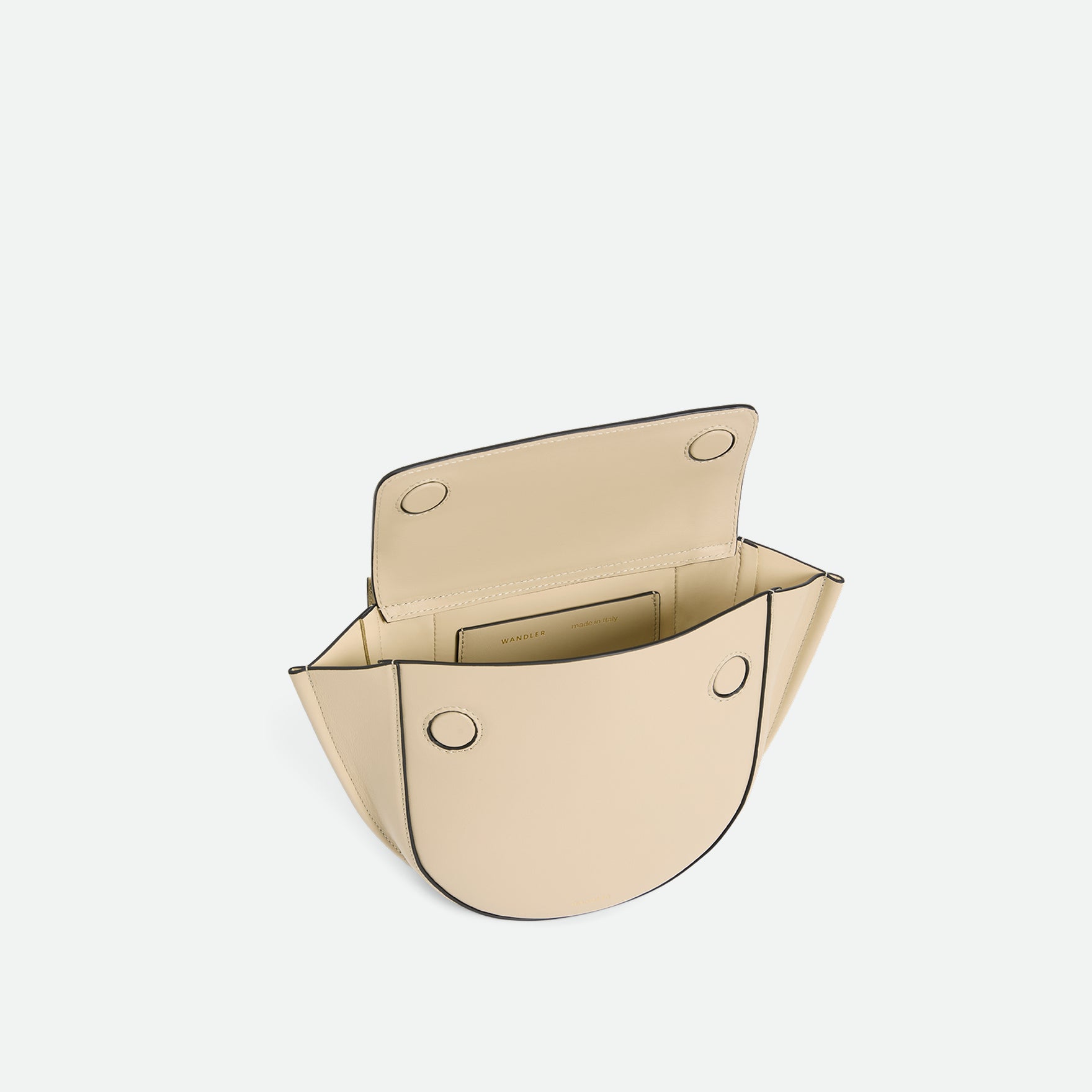 Wandler Hortensia Bag Mini in the color Linen, beige, made from Italian calf leather with golden hardware, rounded silhouette and top handle, bag being pictured from above with the flap open, giving a glimpse into the inside of the bag. 