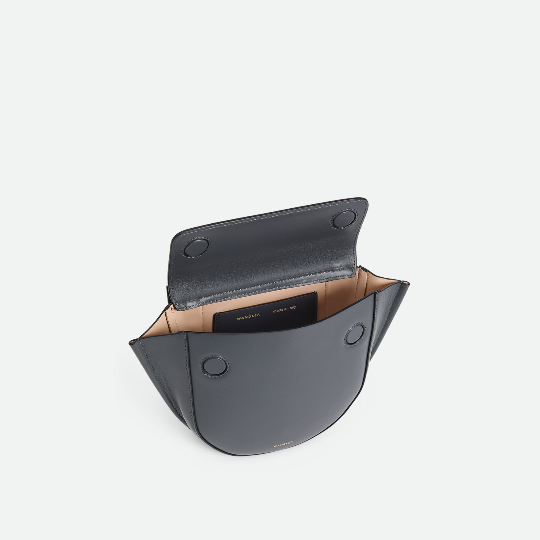 Wandler Hortensia Bag Mini in the color Space, grey, made from Italian calf leather with golden hardware, rounded silhouette and top handle, pictured from above, giving a glimpse of the inside of the bag. 