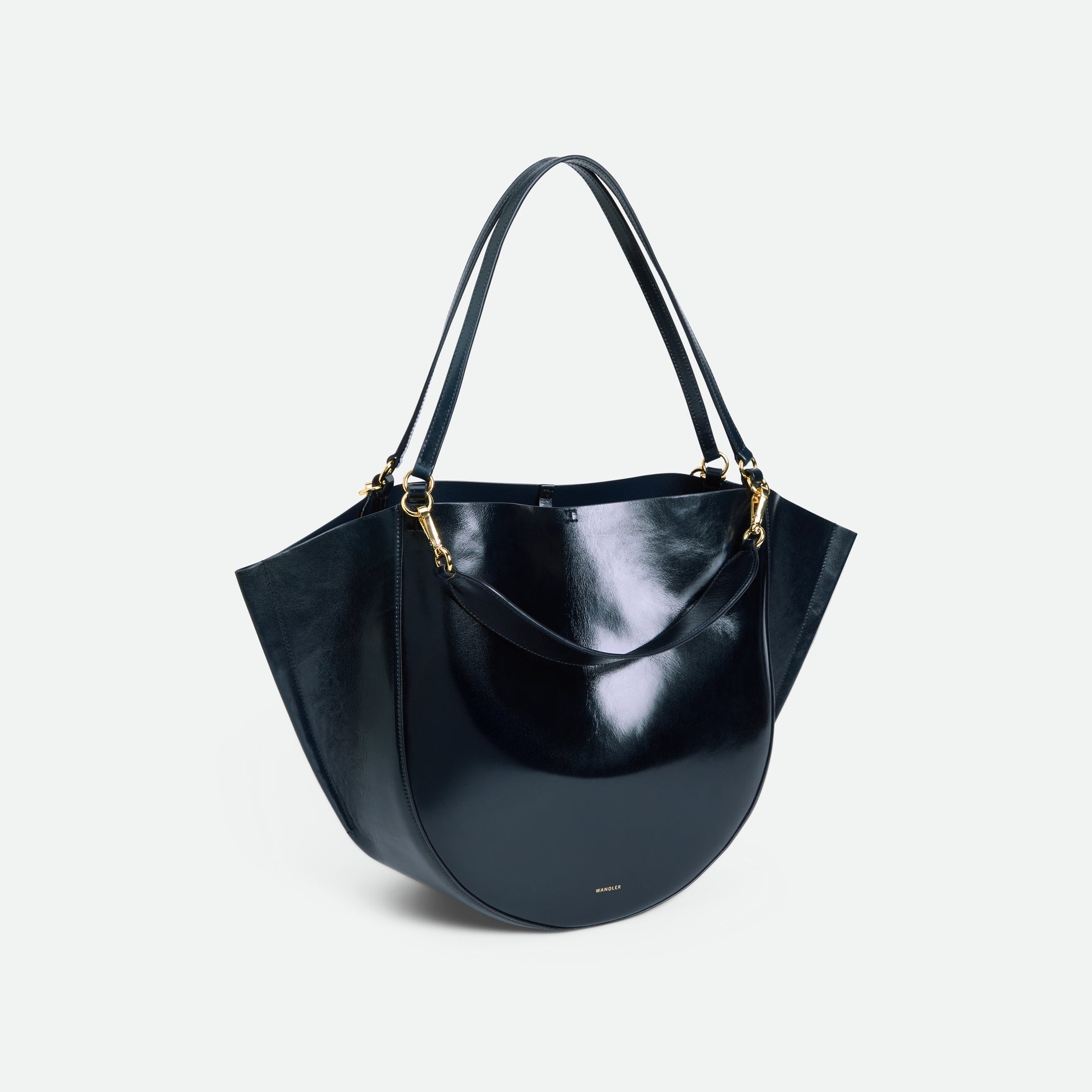 Wandler Hortensia Tote in Orion Glaze Italian calf leather with golden hardware, hand-painted edges and rounded silhouette, three-quarters view.