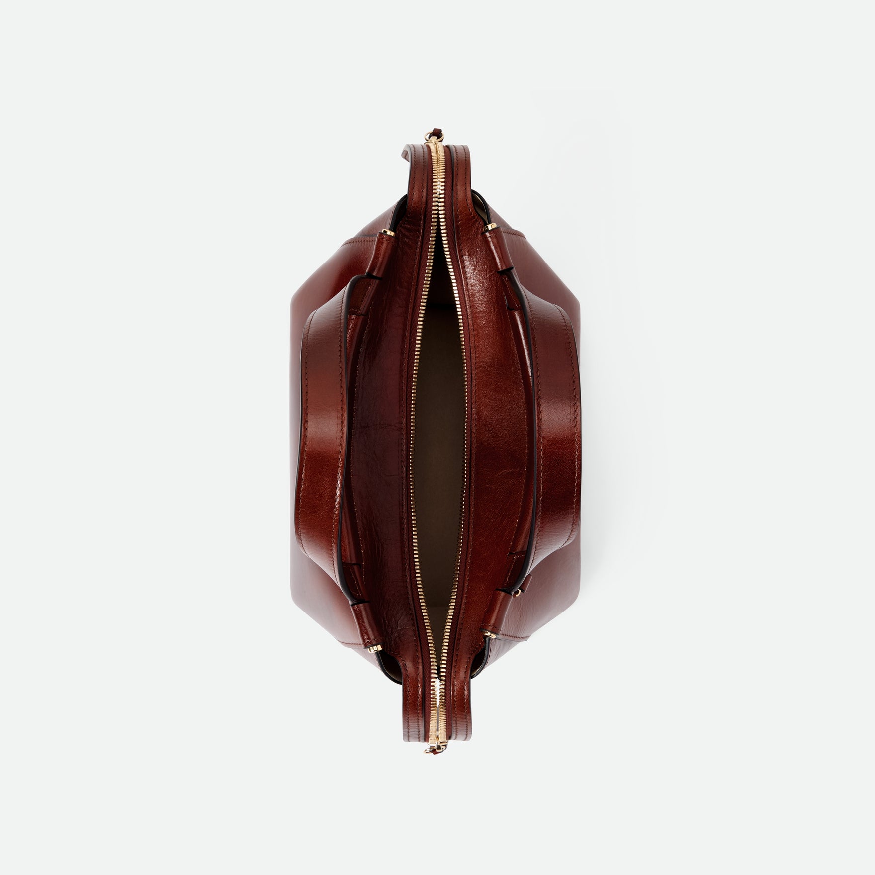 Wandler Ida Bag in the color Palissander Glaze, deep dark brown with red undertones, made from Italian calf leather with golden hardware and sculptural top handle, topside view with open zipper, showing a glimpse of the inside of the bag. 
