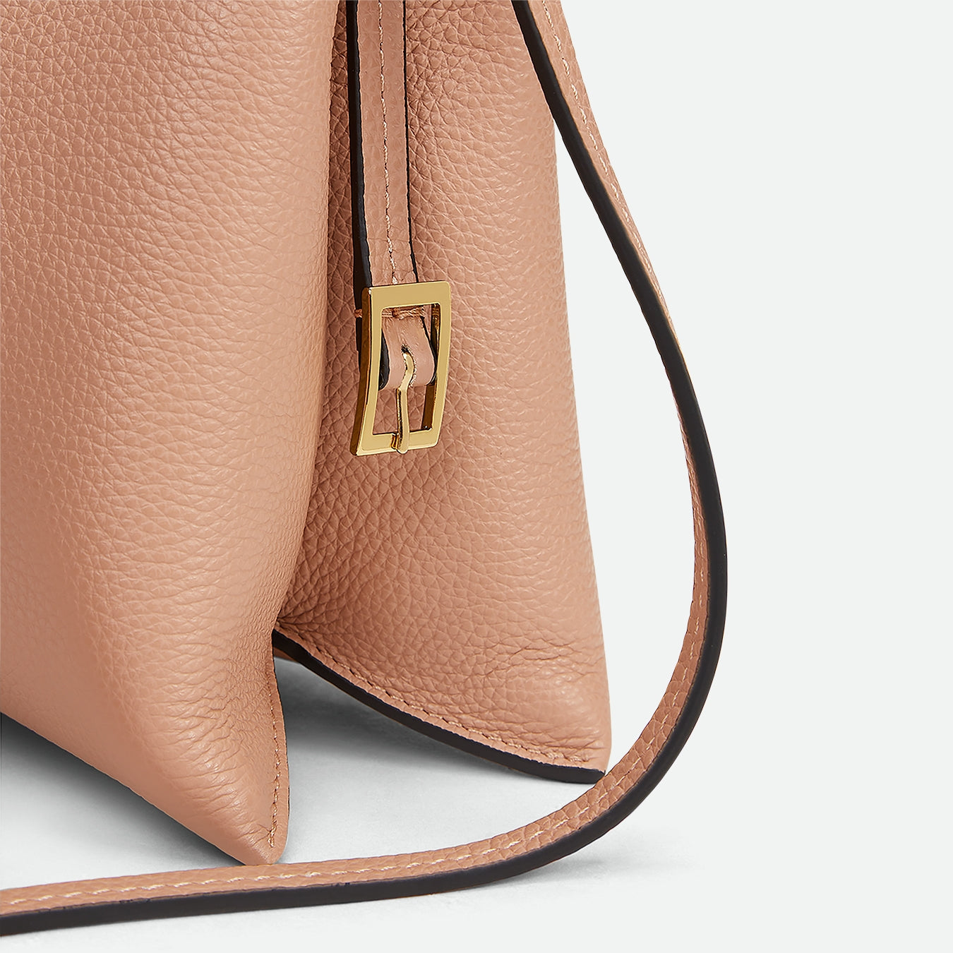 Wandler Penelope Slouch Bag in the color Apricot Crust, made from calf leather with golden hardware and adjustable slim strap, side view.