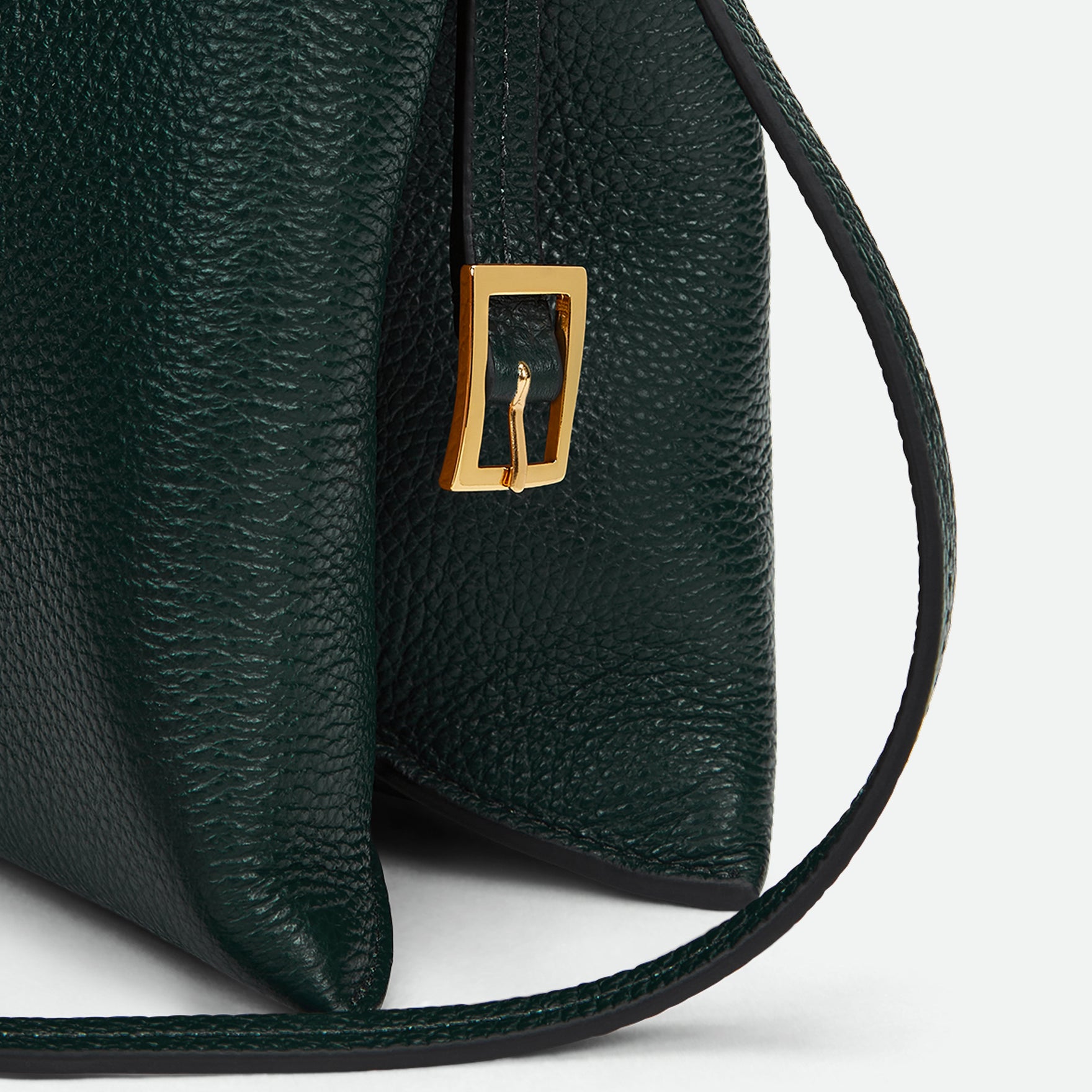 Wandler Penelope Slouch Bag in the color Pine Crust, made from calf leather with golden hardware and adjustable slim strap, close up detailing the clasp.