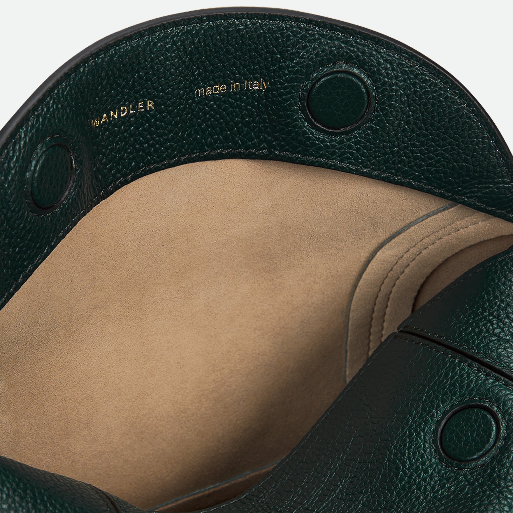 Wandler Penelope Slouch Bag in the color Pine Crust, made from calf leather with golden hardware and adjustable slim strap, close up detailing leather and logo. 