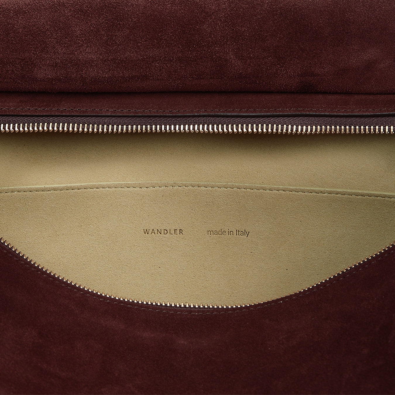 Wandler Penelope Tote in the color Acai Suede, made from Italian calf leather with golden hardware and soft structured silhouette, close up shot detailing inside leather and logo. 