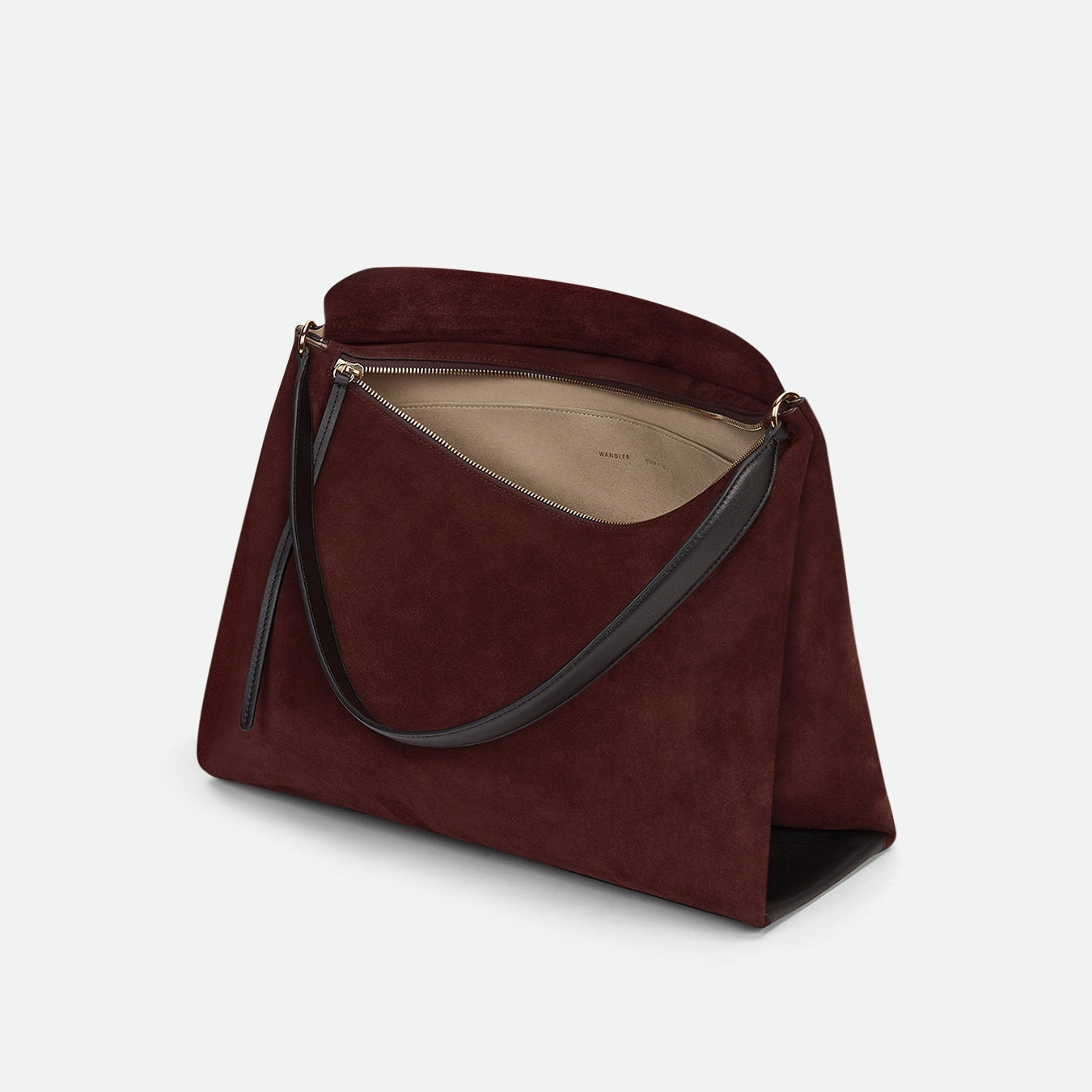 Wandler Penelope Tote in the color Acai Suede, made from Italian calf leather with golden hardware and soft structured silhouette, pictured from above with the zipper open, giving a glimpse into the inside of the bag. 