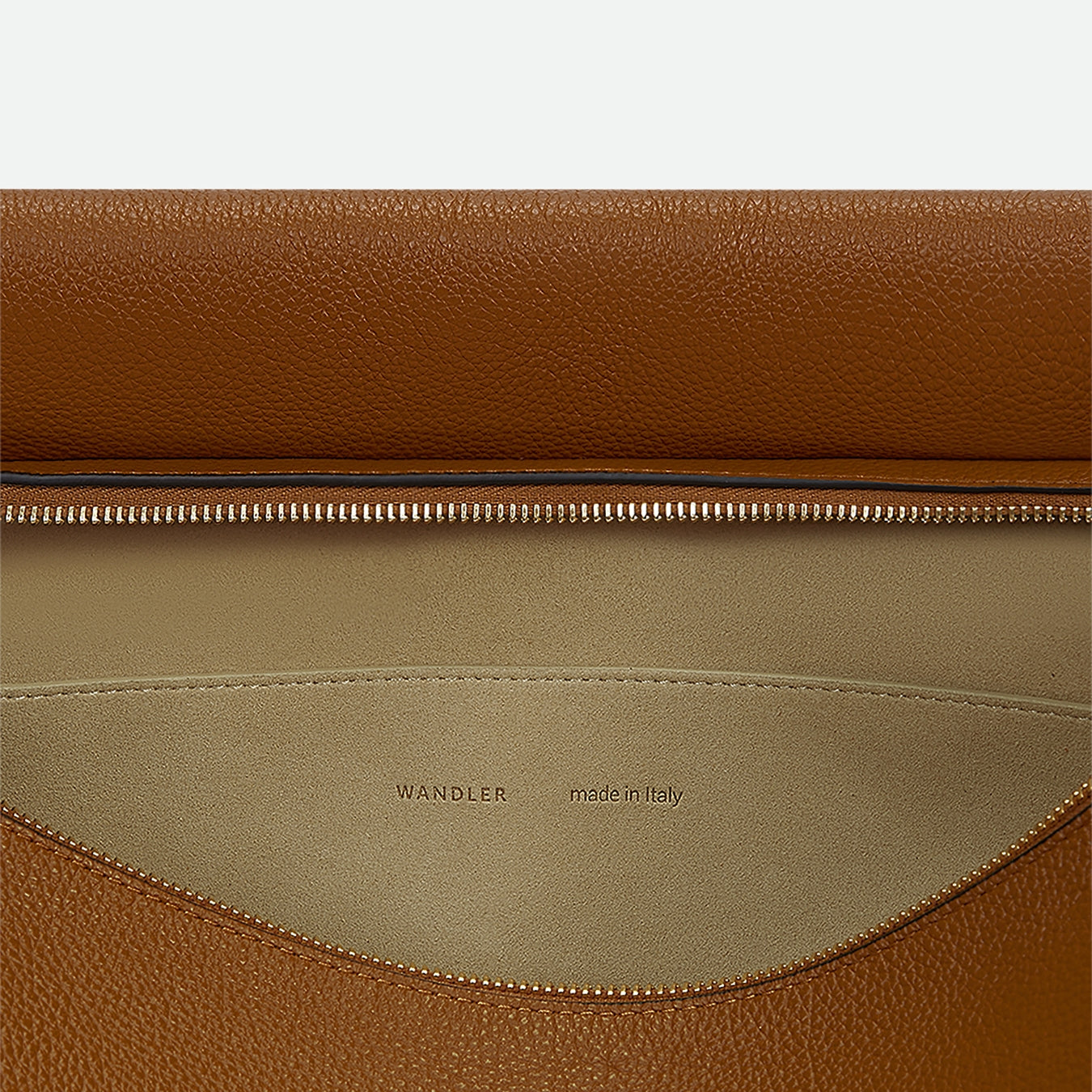 Wandler Penelope Tote in the color Tan Crust, made from Italian calf leather with golden hardware and soft structured silhouette, close up detailing the inner leather and logo.