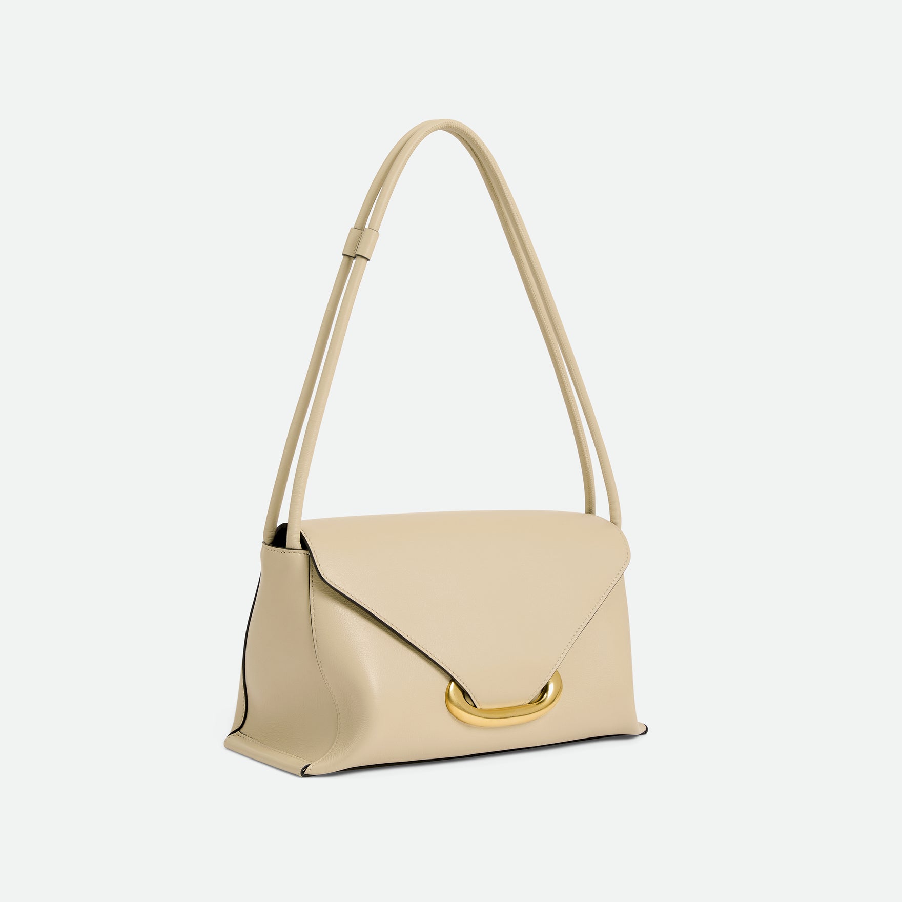 Wandler Veneto Shoulder Bag in the color Linen, beige, Italian calf leather with oversized golden clasp hardware and structured silhouette, three quarters view with the straps suspended into the air. 