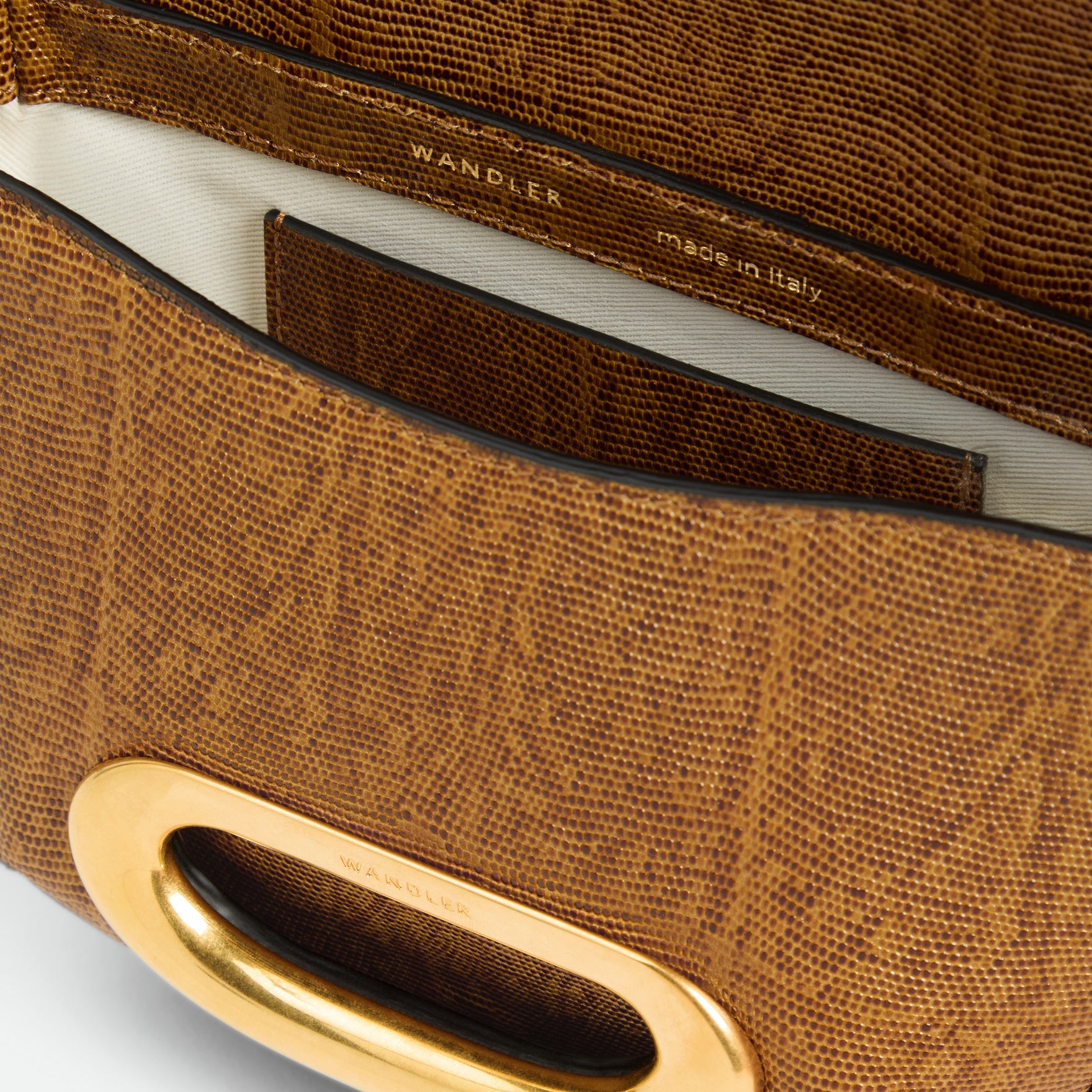 Wandler Veneto Crossbody Small in Tabacco Lizzard, warm brown with lizzard pattern, made from Italian calf leather with golden clasp hardware and structured silhouette, close up detailing the clasp,  leather, with a small glimpse into the inside of the bag. 

