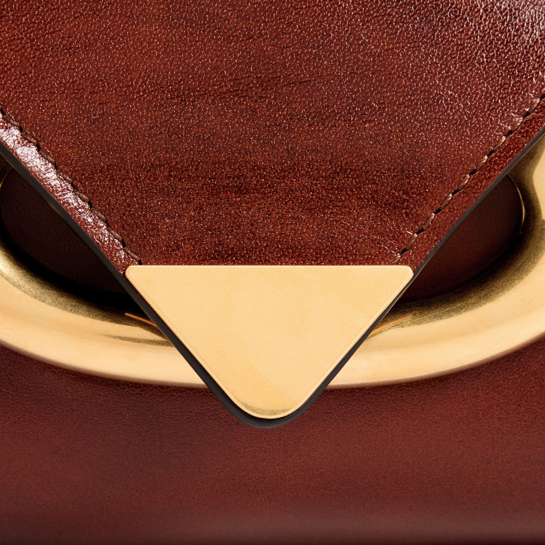 Wandler Veneto Shoulder Bag in the color in Palissander Glaze, deep dark red, Italian calf leather with oversized golden clasp hardware and structured silhouette, close up detailing the clasp and leather. 