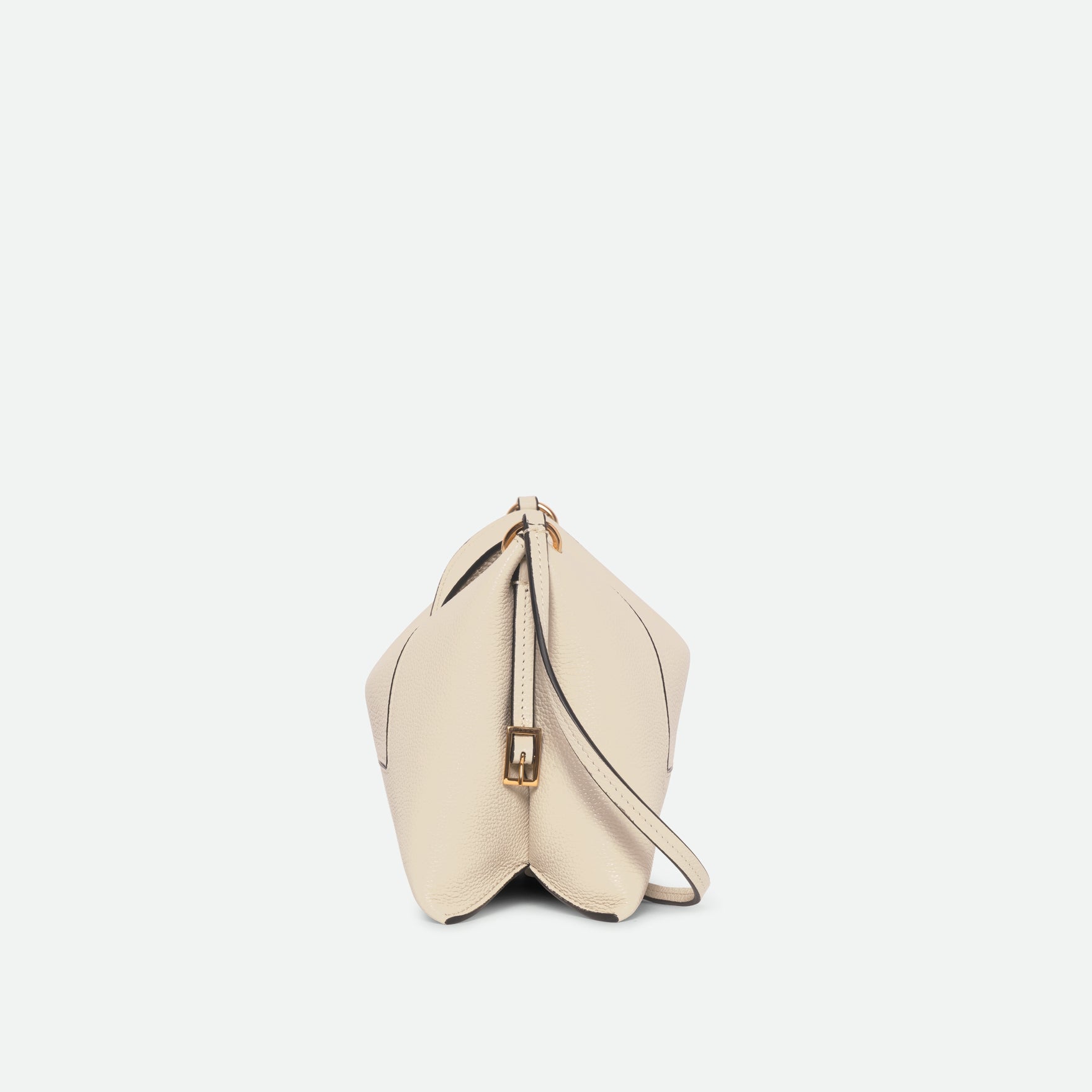 Wandler Penelope Slouch Bag in the colour Beige Crust, beige, made from smooth calf leather with golden hardware and adjustable slim strap, side view.