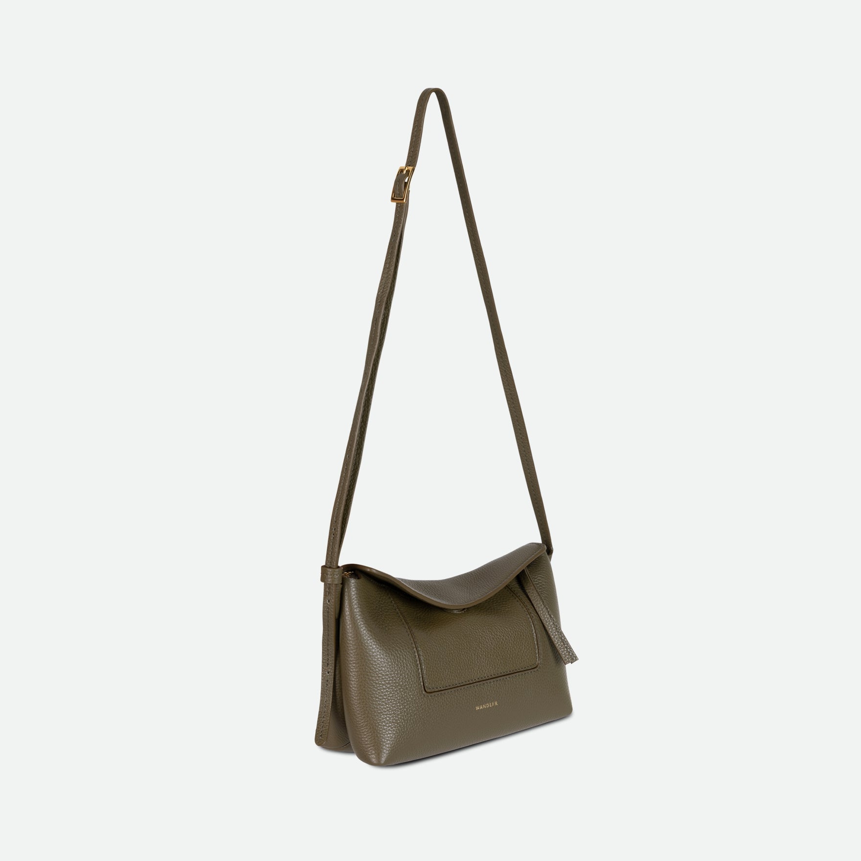 Wandler Penelope Slouch Mini in Olive Crust, green, Italian calf leather with golden hardware and slim adjustable strap, three quarters angle with the crossbody strap suspended into the air.