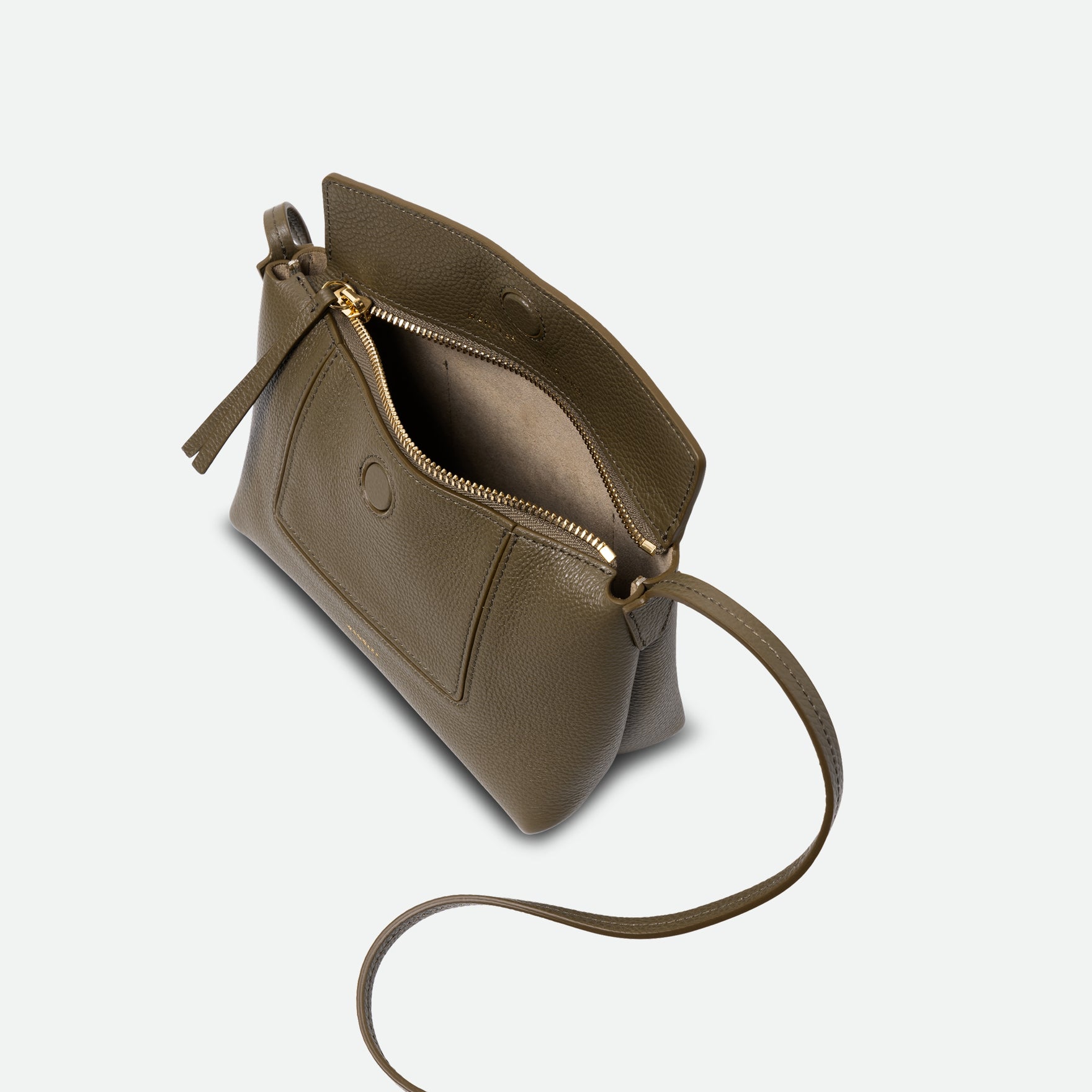 Wandler Penelope Slouch Mini in Olive Crust, green, Italian calf leather with golden hardware and slim adjustable strap, pictured on model worn on the shoulder. The bag is pictured from above with the flap and zipper open, giving a slight view of the inside of the bag.