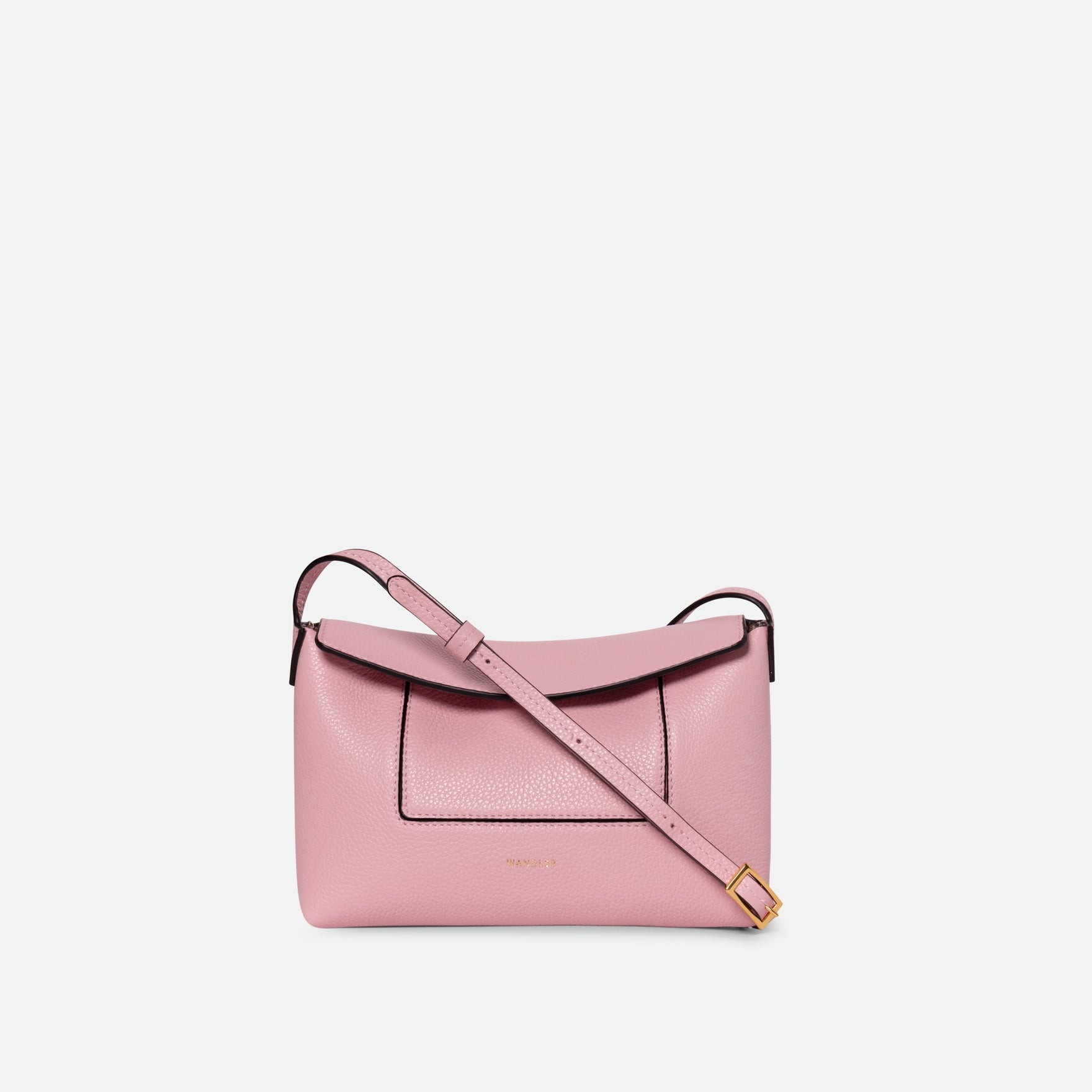 Wandler Penelope Slouch Mini in Rose Crust, pink, Italian calf leather with golden hardware and slim adjustable strap, pictured on model worn on the shoulder. 
