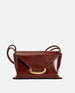 Wandler Veneto Shoulder Bag in the color Palissander Glaze, deep dark blue, Italian calf leather with oversized golden clasp hardware and structured silhouette, front view.