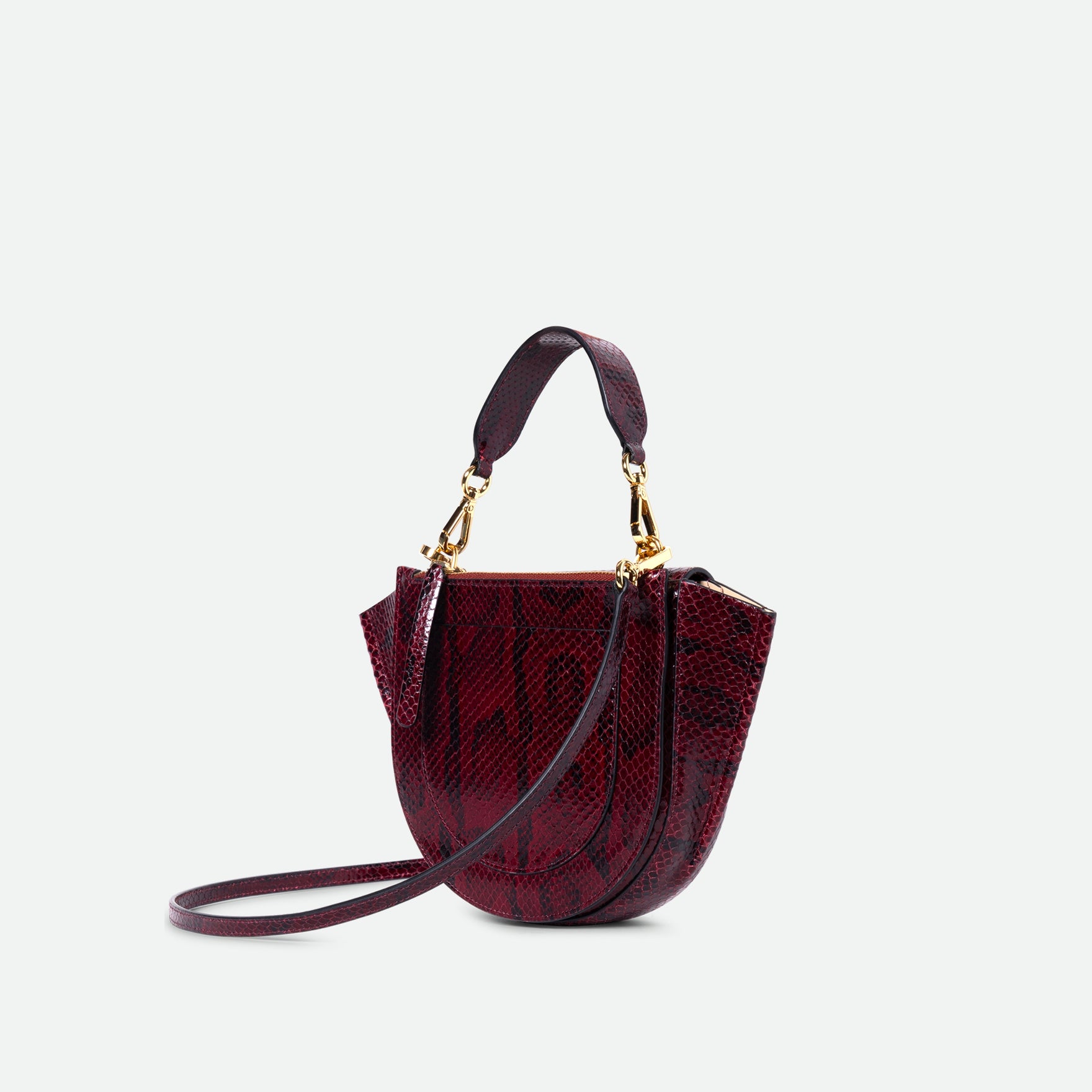 Wandler Hortensia Bag Mini in the color Bordeaux Python, deep dark red with python print, Italian calf leather with golden hardware, rounded silhouette and top handle, three quarters angle, backside view.