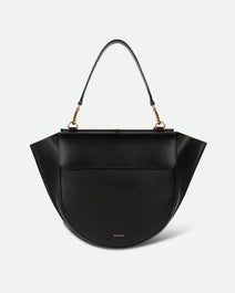 Wandler Hortensia Bag Medium in the color Black, made from Italian calf leather with golden hardware, rounded silhouette and top handle, front view.
