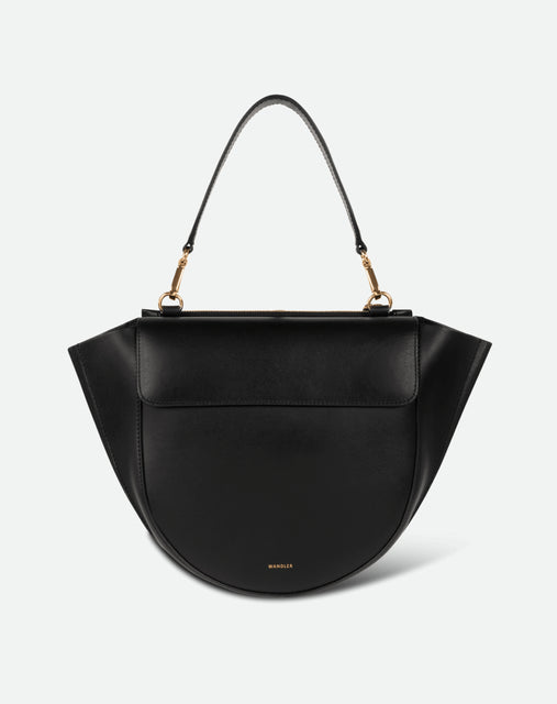 Wandler Hortensia Bag Medium in the color Black, made from Italian calf leather with golden hardware, rounded silhouette and top handle, front view.

