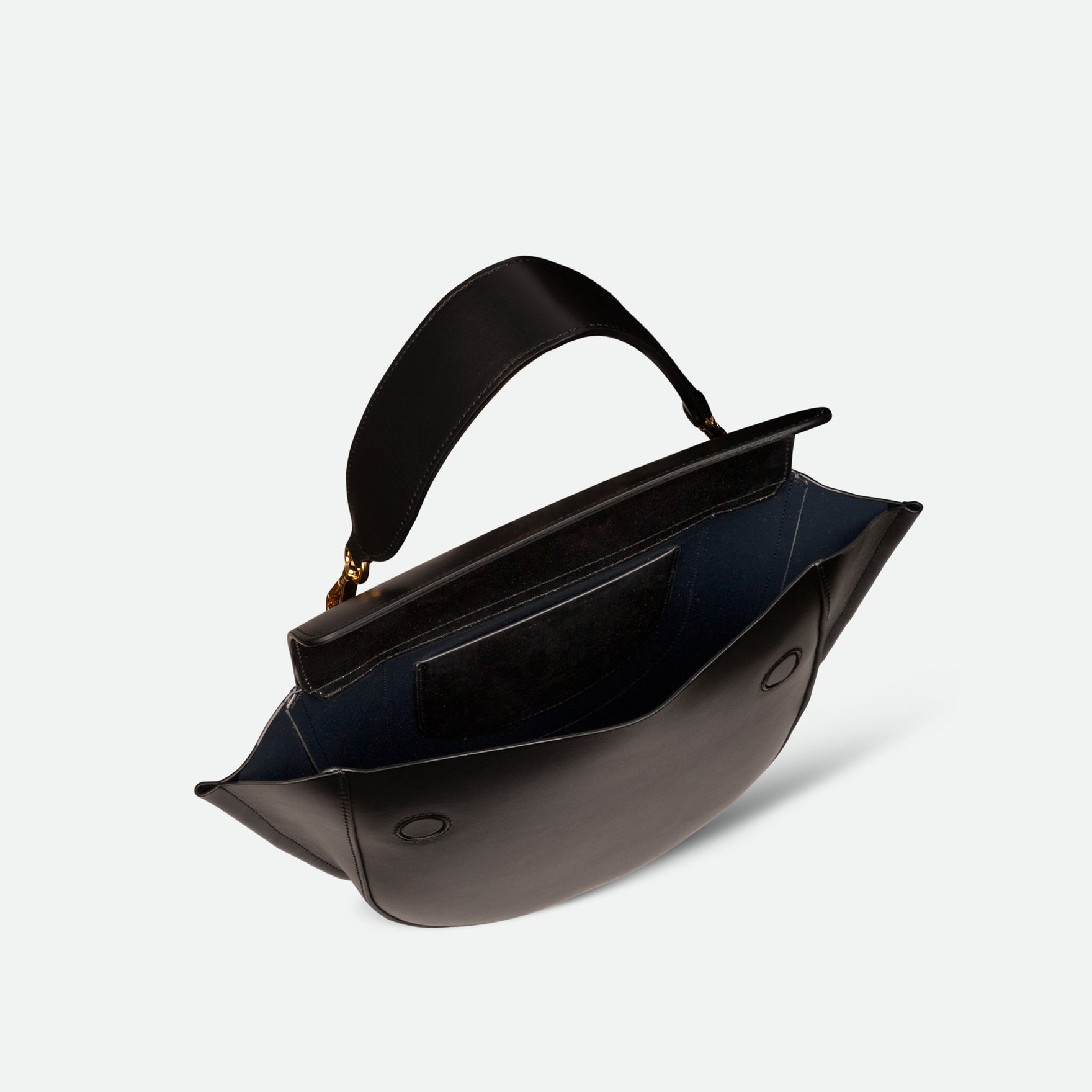 Wandler Hortensia Bag Medium in the color Black, made from Italian calf leather with golden hardware, rounded silhouette and top handle, pictured from above with the flap open, giving a glimpse of the inside of the bag. 