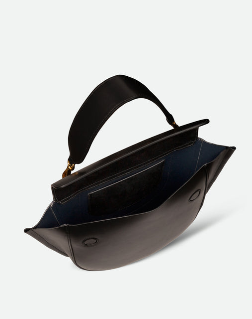 Wandler Hortensia Bag Medium in the color Black, made from Italian calf leather with golden hardware, rounded silhouette and top handle, pictured from above with the flap open, giving a glimpse of the inside of the bag. 