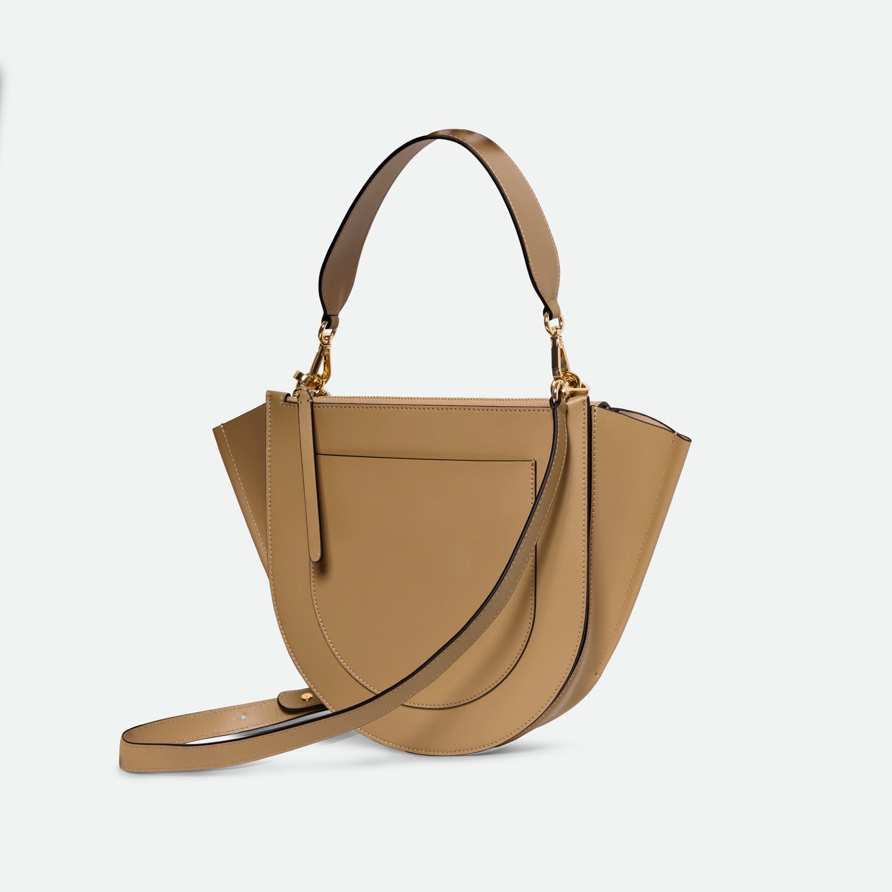 Wandler Hortensia Bag Medium in the color Gingerbread, dark beige, made from Italian calf leather with golden hardware, rounded silhouette and top handle, backside view, three quarters angle. 