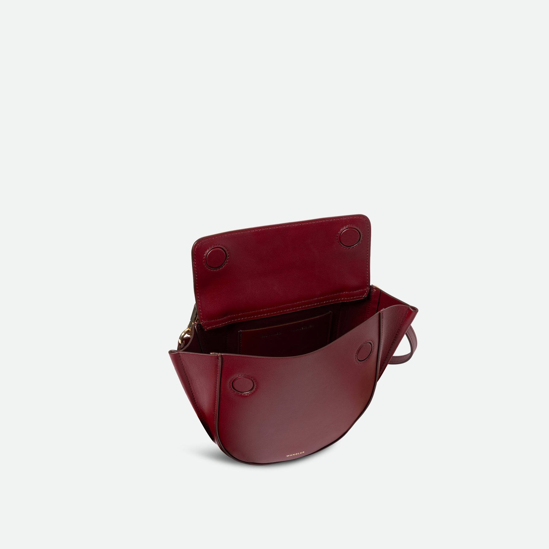 Wandler Hortensia Bag Mini in the color Acai, made from Italian calf leather with golden hardware, rounded silhouette and top handle, pictured with the flap open, allowing for a glimpse into the inside of the bag.