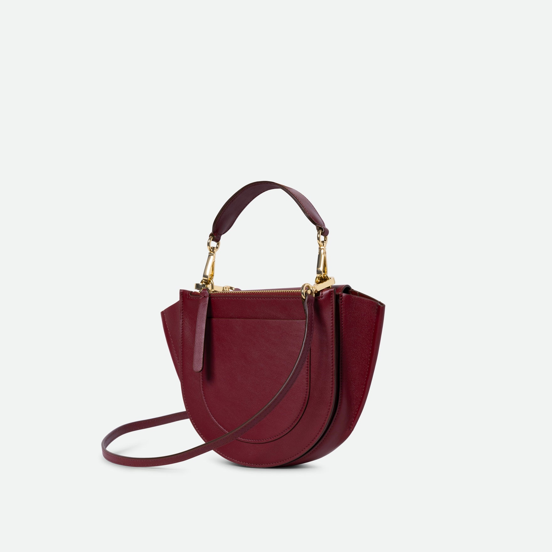 Wandler Hortensia Bag Mini in the color Acai, made from Italian calf leather with golden hardware, rounded silhouette and top handle, backside view.