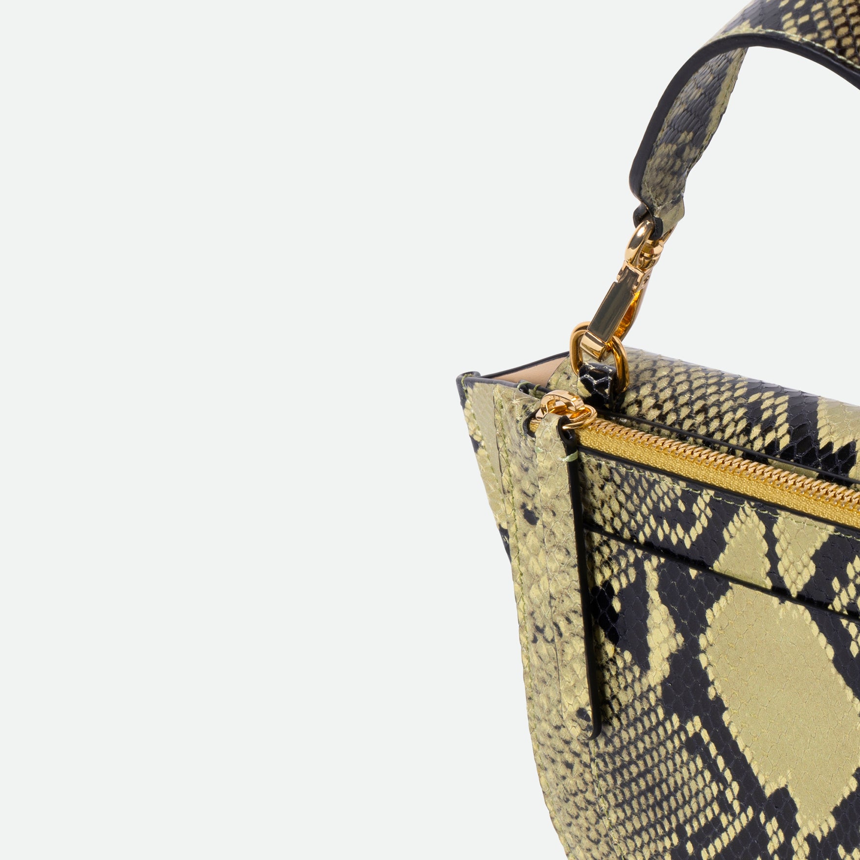 Wandler Hortensia Bag Mini in the color Lime Python, green python print, Italian calf leather with golden hardware, rounded silhouette and top handle. Close up shot detailing the zipper and top handle. 