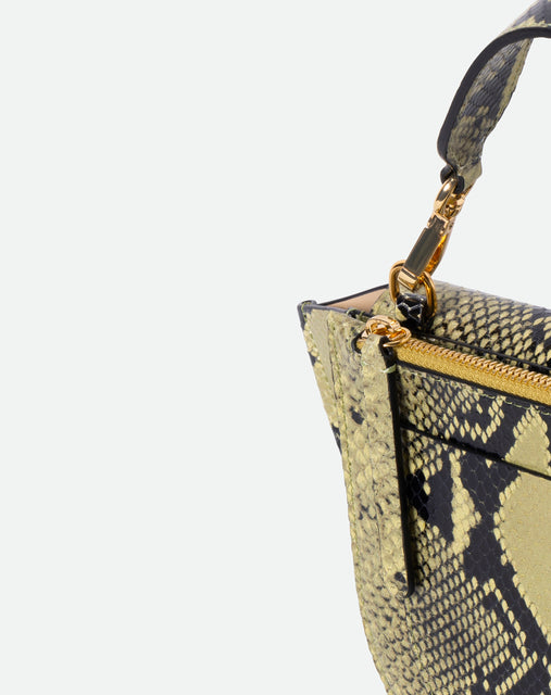 Wandler Hortensia Bag Mini in the color Lime Python, green python print, Italian calf leather with golden hardware, rounded silhouette and top handle. Close up shot detailing the zipper and top handle. 