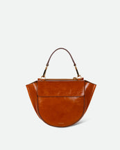 Wandler Hortensia Bag Mini in the color Cognac Eyelets, caramel brown, Italian calf leather with golden hardware, rounded silhouette and top handle, front view.