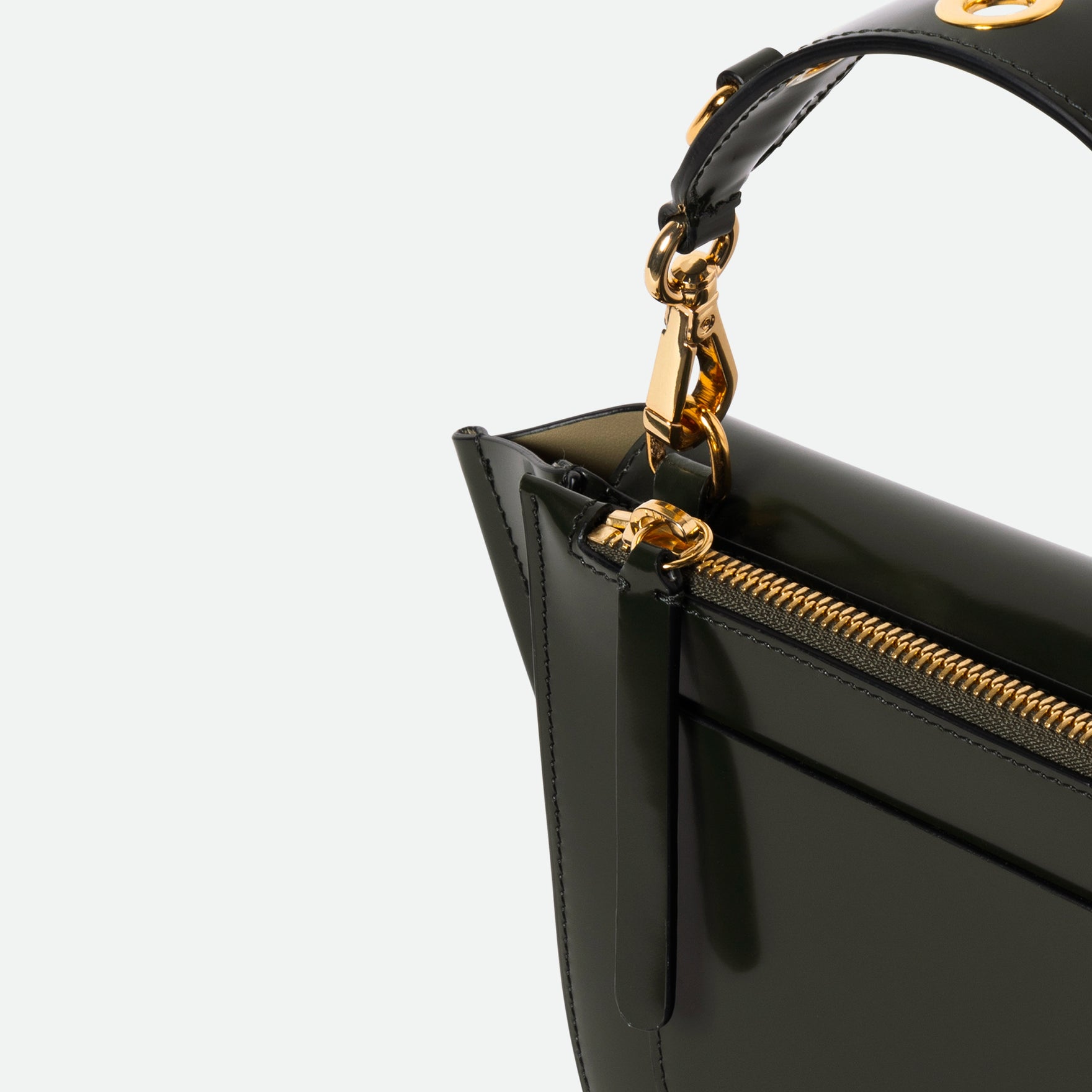 Wandler Hortensia Bag Mini Eyelets in the color Jazz Olive, made from Italian calf leather with golden hardware and rounded silhouette, close up detailing the zipper and leather.
