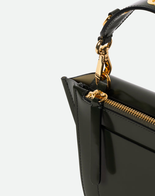 Wandler Hortensia Bag Mini Eyelets in the color Jazz Olive, made from Italian calf leather with golden hardware and rounded silhouette, close up detailing the zipper and leather.