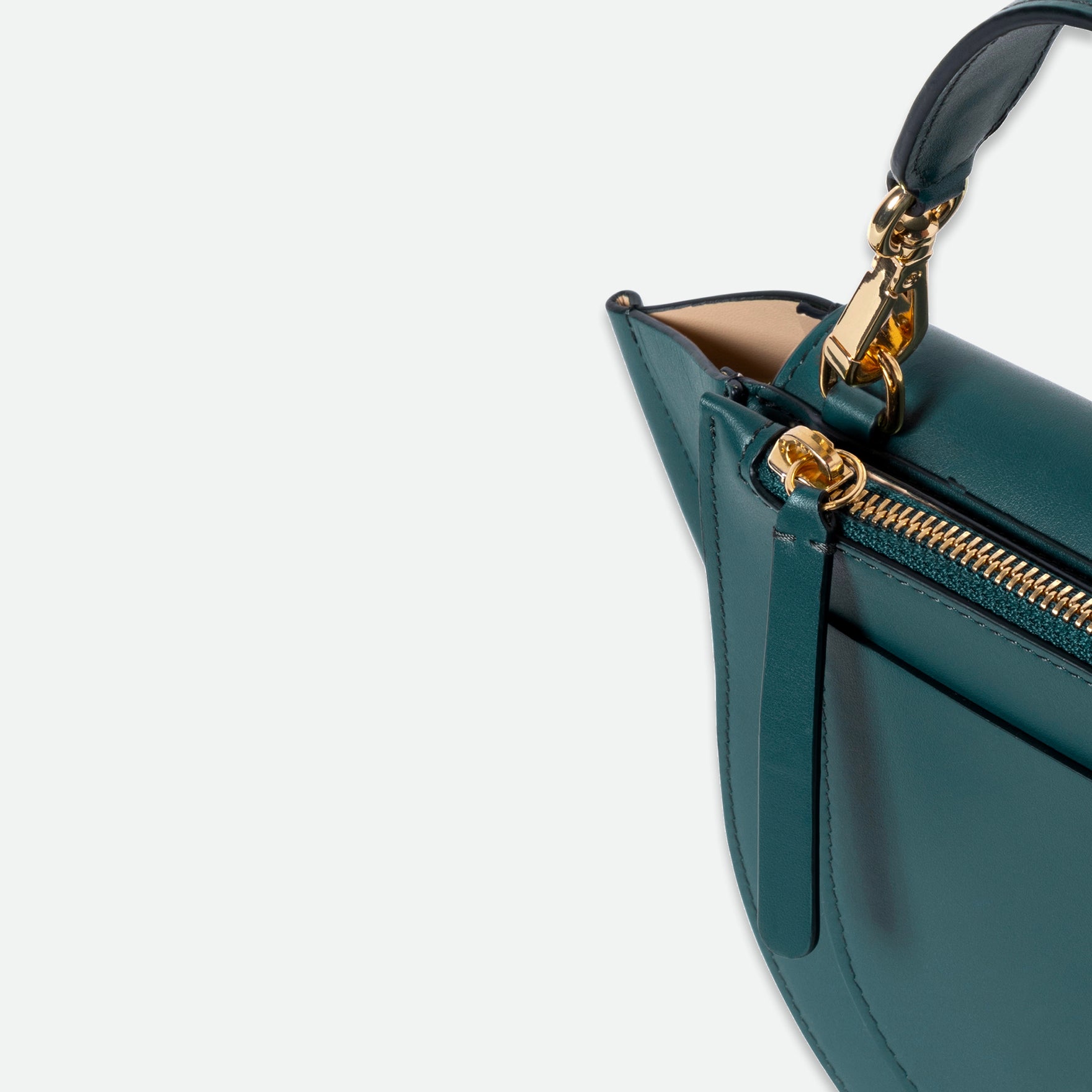 Wandler Hortensia Bag Mini in the color Teal, made from Italian calf leather with golden hardware, rounded silhouette and top handle, close up detailing the handle and zipper.