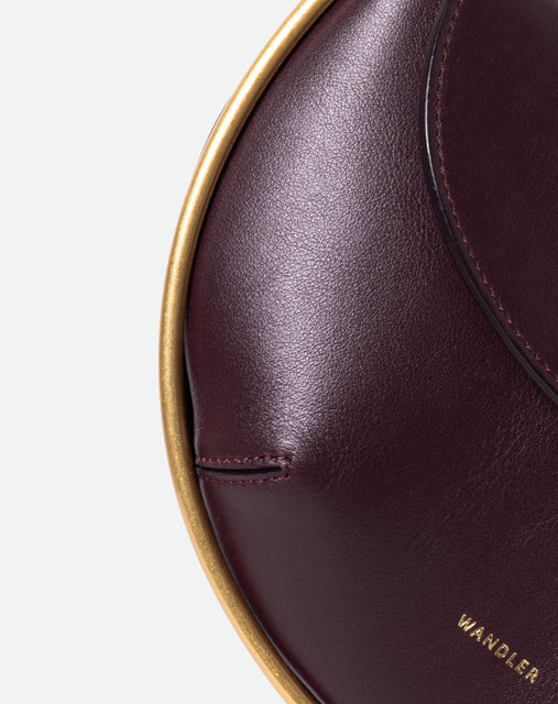 Wandler Kate Mini Crossbody in the color Grape, made from Italian calf leather with golden hardware and adjustable strap, close up detailing the leather.