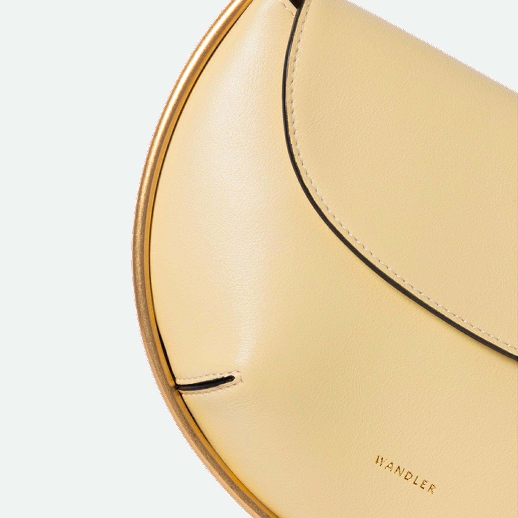 Wandler Kate Mini Crossbody in Helio Italian calf leather with golden hardware and adjustable strap, close up detailing the golden halo detail around the bag.