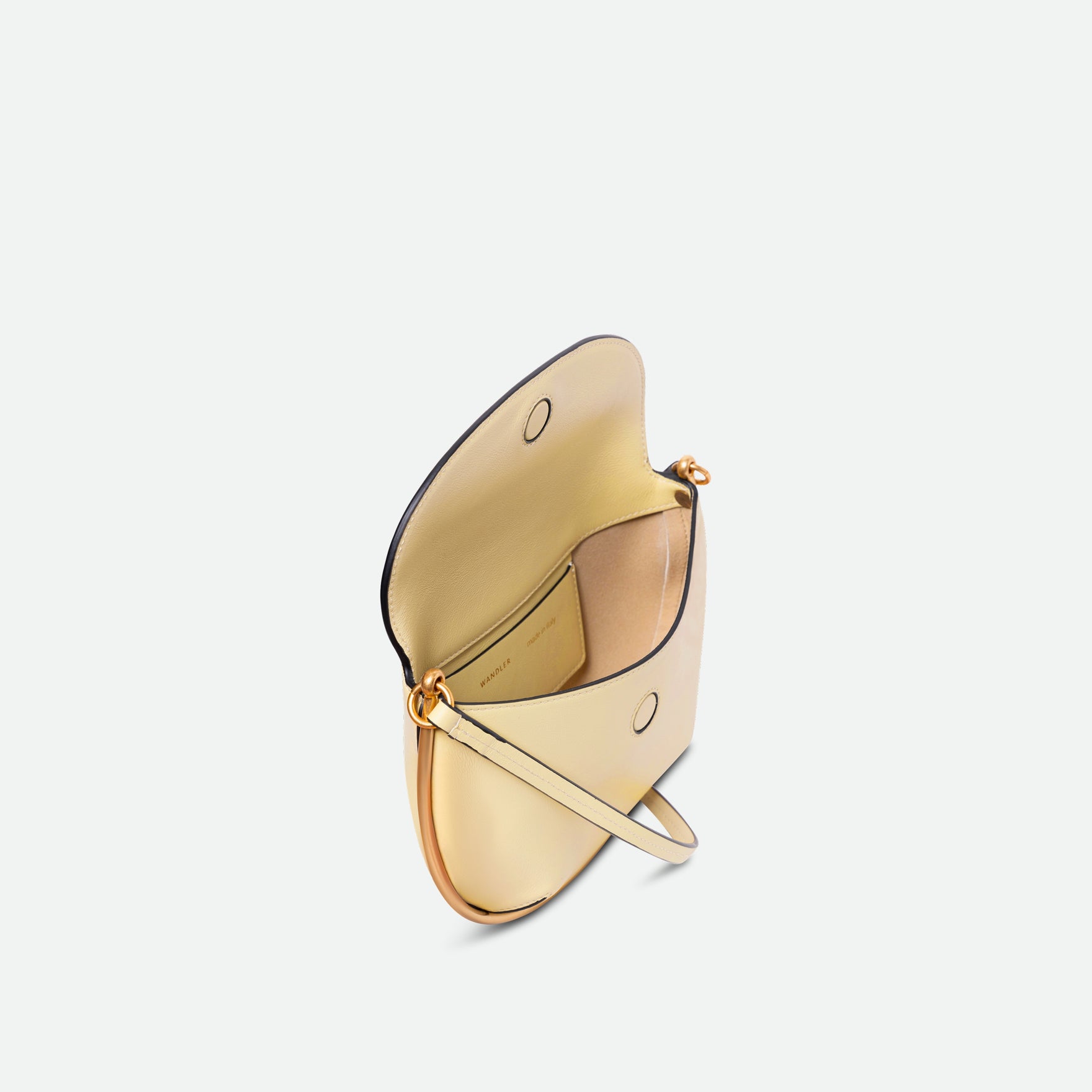 Wandler Kate Mini Crossbody in Helio Italian calf leather with golden hardware and adjustable strap, pictured from above with the bag being open, allowing for a glimpse into the inside of the bag.