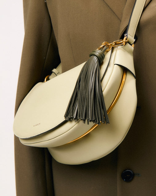 Wandler Bag Charm Olive Tassel, pictured on a Kate bag, being used as a bag charm.