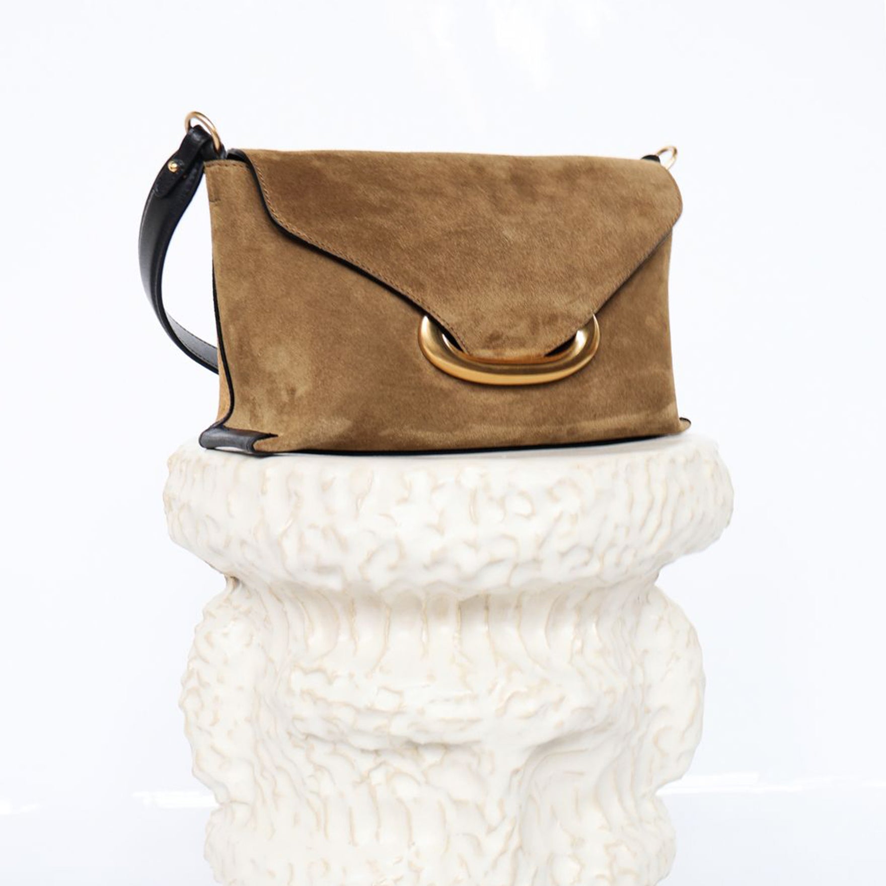 Wandler Veneto Shoulder Bag Small in the color Tabacco Suede, made from Italian calf leather with oversized golden clasp hardware, structured silhouette, three quarters view.